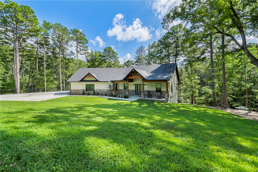 Check out this one of a kind property featuring a custom home sitting on seven adjoining lots totaling 2.39 acres. Enjoy your very own private street and cul-de-sac. The house features hard wood flooring, a 3-car garage with epoxy floor coating, upgraded KraftMaid cabinets, Walker Zanger countertops, and Pacific Place Wood burning stove. Each empty lot has been professionally manicured with trimmed trees and brush/leaf removal. The wood burning stove and upgraded Blow-in and Foam insulation results in a $115 a month average electric bill. The oversized 80 gallon water heater ensures you can fill the custom 6ft tub without running out of hot water. Enjoy the view of nature on the screened in back porch. Bedrooms include oversized windows that bring the outside nature inside. There's a 6-ft rollup door under the house featuring a 10x25 concrete pad for storage of mowers and yard tools. Feel safe with the Ring multi-camera system covering the front of the house and driveway.