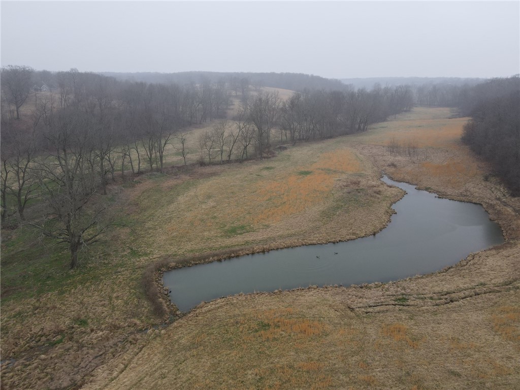 One of the prettiest farms/land you will find in NWA. Three continuous parcels for a total of 242.33 +/- acres with live water running through it and several ponds just outside of Decatur or 20 mins to Bentonville. Approximately 128 acres of good pasture and 114 acs of timber and perfect cover for the abundant deer and wildlife. The home is approximately 2900 sqft and 85% finished in 2016 (as is) but very livable with enormous potential. Property also includes a barn and old mobile home (also as is). Great chance to own your own paradise in the heart of NWA but away from the hustle and bustle!