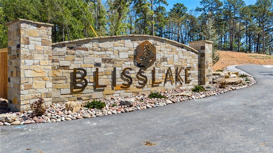 Discover the perfect canvas for your custom Beaver Lake area retreat at Blisslake, a new fully paved subdivision featuring 9 premier estate-sized lots with dedicated community recreation area and lakefront access for all lot owners. This 4.72-acre lot offers the ideal blend of privacy, natural beauty, & proximity to some of Northwest Arkansas' most sought-after amenities. Ideally located at the Northern end of Beaver Lake near Hobbs State Park & Rocky Branch Marina, the property is surrounded by endless opportunities for hiking, biking, boating, & outdoor recreation as well as just 20 minutes from downtown Rogers! The sloping terrain & serene wooded setting provide an exceptional backdrop for a luxury home designed to complement the Ozark landscape. Underground electric & water are available at the street, allowing for a visually clean, unobstructed setting while streamlining the building process. Build your dream home & experience the best of the Natural State!
