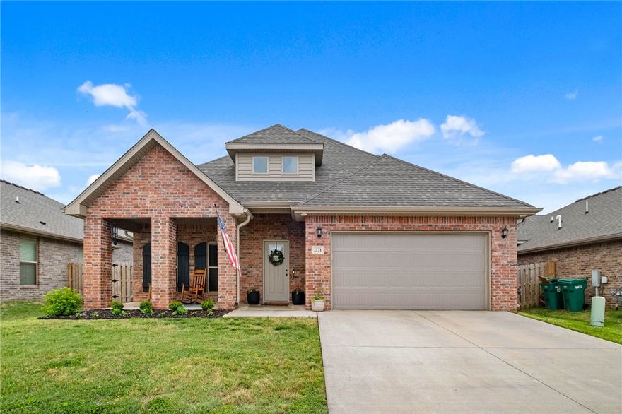 Discover the essence of modern living at 2131 Periwinkle PL in Centerton, Arkansas. Built in 2022, this single-family residence is in great condition, offering an attractive property for discerning homeowners. The heart of this home is its open-plan kitchen, seamlessly flowing into the living room. The kitchen is equipped with matching black appliances and features a convenient peninsula, ideal for casual dining or entertaining. The adjacent living room provides a comfortable gathering space, anchored by a welcoming fireplace. Retreat to one of the three well-appointed bathrooms, each designed for comfort and ease. The primary bathroom offers the luxury of two sinks and a spacious walk-in shower. The home provides three comfortable bedrooms for private relaxation. Beyond the interior, a private yard offers outdoor living space for enjoyment. An attached garage provides convenience, while a dedicated laundry room simplifies daily routines. Enjoy the outdoors from either the inviting patio or the charming porch.