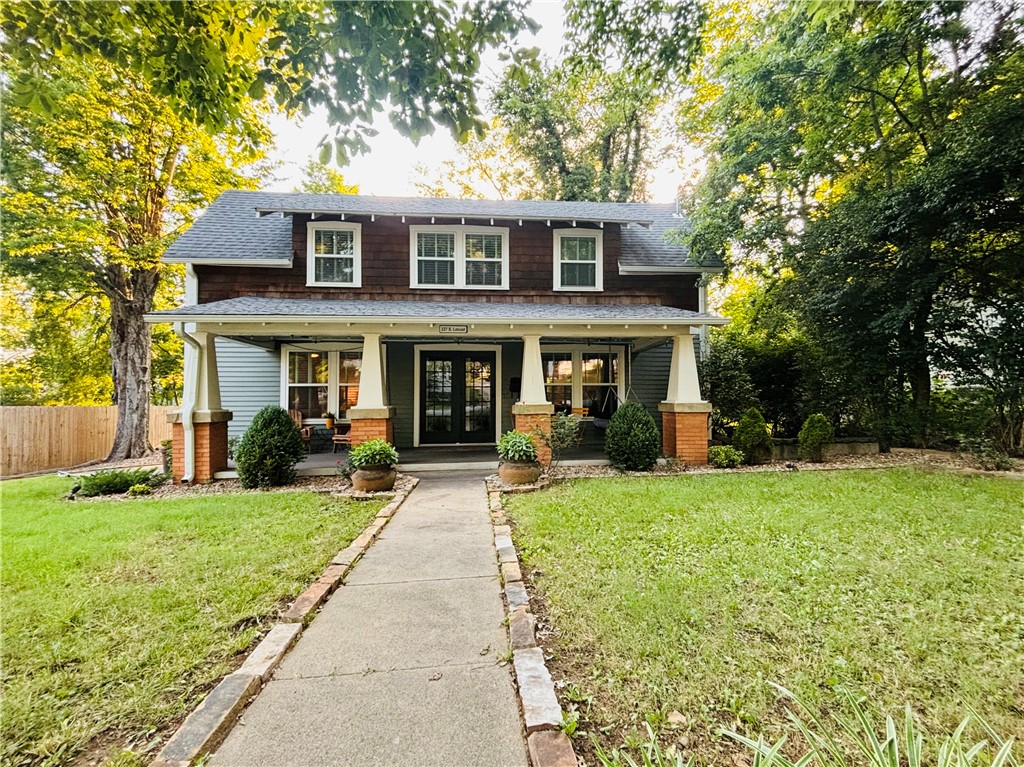 Enjoy easy access to everything from this lovely, centrally located home! This historic home was previously renovated from top to bottom and has a dreamy front porch, spacious backyard, and beautiful interior design. Walking distance to the University of Arkansas, downtown Fayetteville, the Mill District, the Ramble, and many restaurants and breweries. There are unique built-ins throughout, a cozy fireplace, and plenty of charm. The brick patio in the backyard is a perfect location for a fire pit, grill, and outdoor seating. This is a rare opportunity to be located on a quiet, shady street, with a large yard and space to relax, yet still right in the heart of it all. One block from the newly expanded public library and a short walk to the Farmerās Market and Razorback Greenway. This historic charmer has it all!