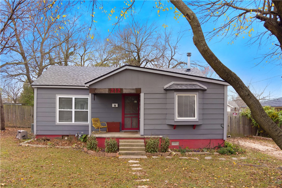 Eclectic bungalow just blocks away from vibrant, historical downtown Rogers that offers unique experiences in cuisine, shopping, music, parks and arts along charming bricked streets.
Home has many special features such as vintage lighting fixtures, bathroom vanity, barn tin back drop behind wood burning fire place, beams in the living area, antique license plate wall in bathroom with built-in medicine cabinet and accent beams in living room. Kitchen lockers are from Fort Smith high school in the 50s. Lockers still have lock and keys. Enjoy the view of backyard oasis from shower.
Spacious backyard has an abundance of space for hot tubing, grilling or just chilling outdoors under the shade trees. Home has many upgrades including roof, windows, insulation, exterior siding, plumbing, electrical and light fixtures. Covered front porch is great for sitting and adds to the curb appeal.