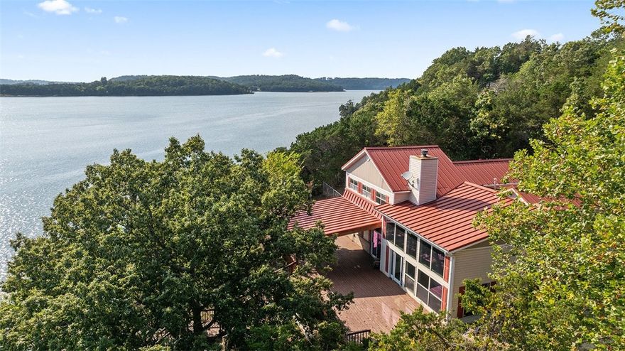PRICE IMPROVED! Seller offering a 2/1 interest rate buy down with the seller's preferred lender.  Experience the best of lakeside living with this 3 bed, 3 bath, 3,175 sq ft home on Beaver Lake, just minutes from Rocky Branch Marina. With a property line that extends to the water’s edge, this unique property is perfectly positioned to offer breathtaking panoramic views of Beaver Lake. Inside, a light-filled living room showcases expansive lakefront windows. The recently remodeled kitchen features quartz countertops & modern finishes, while the updated bathroom adds a touch of luxury. Upstairs, a spacious flex room serves perfectly as a home office or easily converts into a 4th bedroom.  Additional highlights include a new HVAC system, a metal roof, a 24x21 covered deck ideal for entertaining, and a detached 30x20 garage with ample storage for your lake toys.  Enjoy direct lake access with your own private boat/PWC lift just steps from the home.