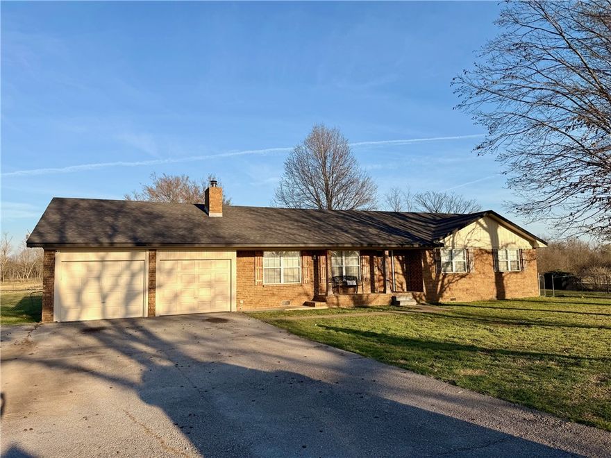 Enjoy quiet country living just outside Prairie Grove on approximately 1.58 acres. This updated 4-bedroom, 2-bath home offers 1,990 sq ft with an open layout, cathedral ceilings, granite countertops, and a cozy wood-burning fireplace. Room off of kitchen can also be used as a mudroom, storage, guestroom or oversized pantry! Step outside to an in-ground pool and a spacious yard with minimal landscaping—providing a clean slate to design your own custom outdoor oasis. Additional features include a 2-car garage, wellhouse, and recent updates throughout. Move-in ready with room to make it your own!