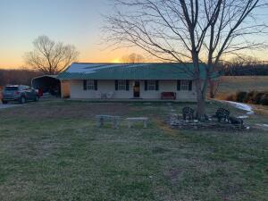 Like new move in ready maintenance free fresh remodel metal roof concrete siding upgraded appliances new laminate floors just out of town on a quiet street with room for a garden and great view across open field Can go to Harrison or Bergman schools