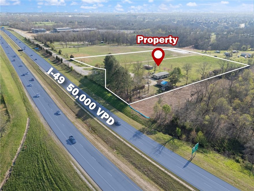 +/- 6.62 acres of prime land with excellent visibility from the primary corridor of NWA, I-49. The property is located just 1.5 miles from Exit 88 and the proposed Alice Walton Health Care Campus, and only minutes away from Walmart's new HQ campus, Crystal Bridges, and Amazeum. Located just outside Bentonville city limits with agricultural zoning, offering endless potential. Bentonville, ArDOT, and the Federal Highway Administration proposed upcoming infrastructure plans include a new J St interchange, extending NE J St northward from Tiger Blvd. across I-49 for approx. 1.1 miles in Bentonville and future connection between N McCollum Dr to J St, with McCollum Dr/Ivy Cir. to the end of McCollum St being expanded into a three lane road. The property has city water, Carroll Electric on site, natural gas less than a mile away and sewer access 900ft SW of the site. Surrounded by scenic trails, this site is excellent for multifamily, office, retail development, church, dealerships, or many other mixed use developments.