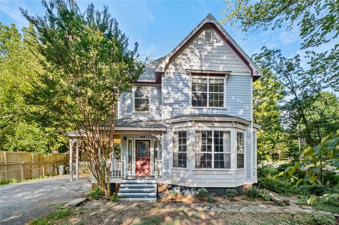 Located in the Washington-Willow Historic District, this 3 bedroom, 2.5 bath home blends historic charm and modern convenience. Walking distance to University of Arkansas main campus, Ozark Natural Foods, Washington Elementary School, and Fayetteville downtown square/Dickson Street. Perfect for U of A faculty and staff or graduate students. Recent updates include new gas stove and microwave, washer and dryer, central AC/heat, energy efficient windows, and beautiful wood floors. An open plan kitchen, dining, and living area provide ample space for family and friendly gatherings. Master suite features an ensuite bathroom and walk-in closet. Two additional spacious bedrooms or home office spaces upstairs with lots of natural light. Other features include a fenced backyard, carport, and newly constructed four-season porch. Enjoy this home's serene creekside setting as well as its proximity to the Razorback bike trail and downtown Fayetteville amenities.