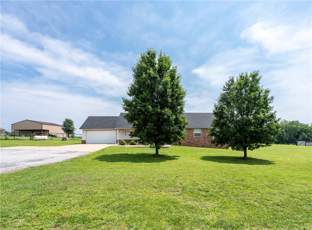 Nice 3 bedroom/ 2 bath/ 2 car garage mostly brick home on 1.89 Acres. Great location just outside of town. Covered front and back porch. Nice big back yard. Newer Roof and central heat and air unit. Close to the walking trail.