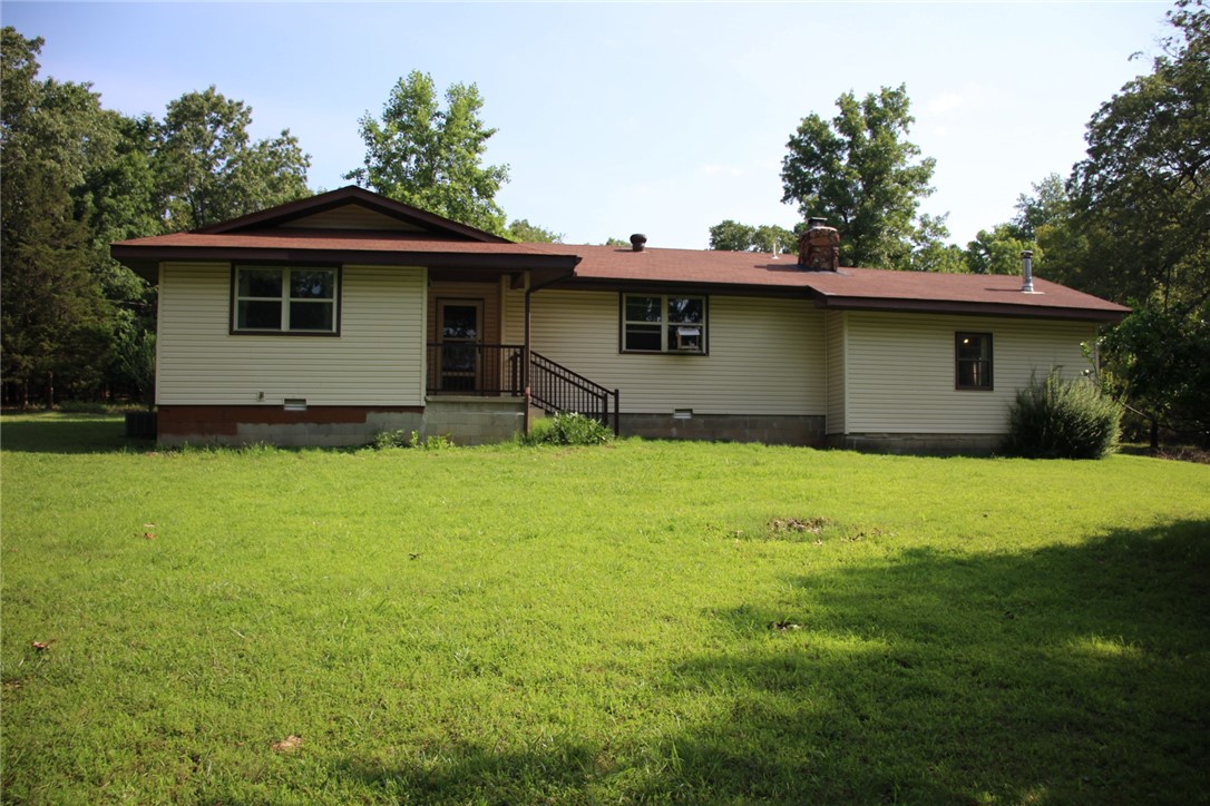 Country life at its best. This 2 bed, 2 bath home sits on just over 6 acres with fenced pasture and a stocked pond. Sitting off the county road with gated entrance for privacy. Fruit trees and room for a garden. Home is 2 bed but has a bonus room that could be a third room or family room. Attached carport and detached shop/garage with work benches and wood stove. Home sold with contents.