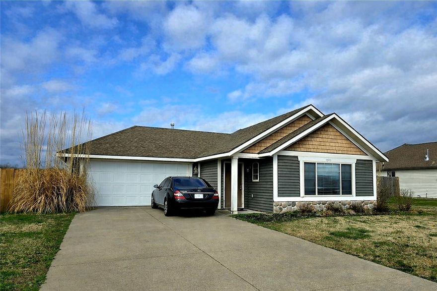 Come see this craftsman-style 3BR, 2BA home with 1,233 sq ft and a 2-car garage in the heart of Prairie Grove! This inviting property features a spacious living area with a cozy gas log fireplace and a comfortable dining space, perfect for everyday living or entertaining. The home offers a landscaped yard and a peaceful setting in a quiet neighborhood. Some appliances convey, making this home move-in ready. Enjoy the nice-sized backyard with plenty of space to relax or play, complete with a privacy fence. Conveniently located within walking distance to Prairie Grove Schools and close to emergency services, shopping, parks, the library, and more. Experience small-town country living just 13 miles from the University of Arkansas.