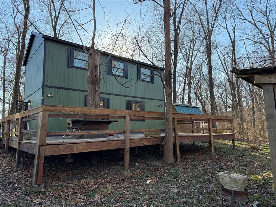 Hidden Gem awaits, secluded yet close to everything with a lake front retreat setting, rare find close to Har-Ber Schools, well water, septic, and wired storage building on site, Lake Elmdale is a 160 acre lake built in 1953 with excellent fishing, launch your fishing boat from this property or the loading ramp is on the other side of the Lake , close to Brush Creek Golf Course.  Being sold AS IS