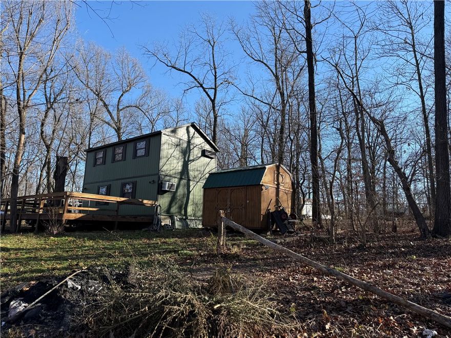 Hidden Gem awaits, secluded yet close to everything with a lake front retreat setting, rare find close to Har-Ber Schools, well water, septic, and wired storage building on site, Lake Elmdale is a 160 acre lake built in 1953 with excellent fishing, launch your fishing boat from this property or the loading ramp is on the other side of the Lake , close to Brush Creek Golf Course.  Being sold AS IS