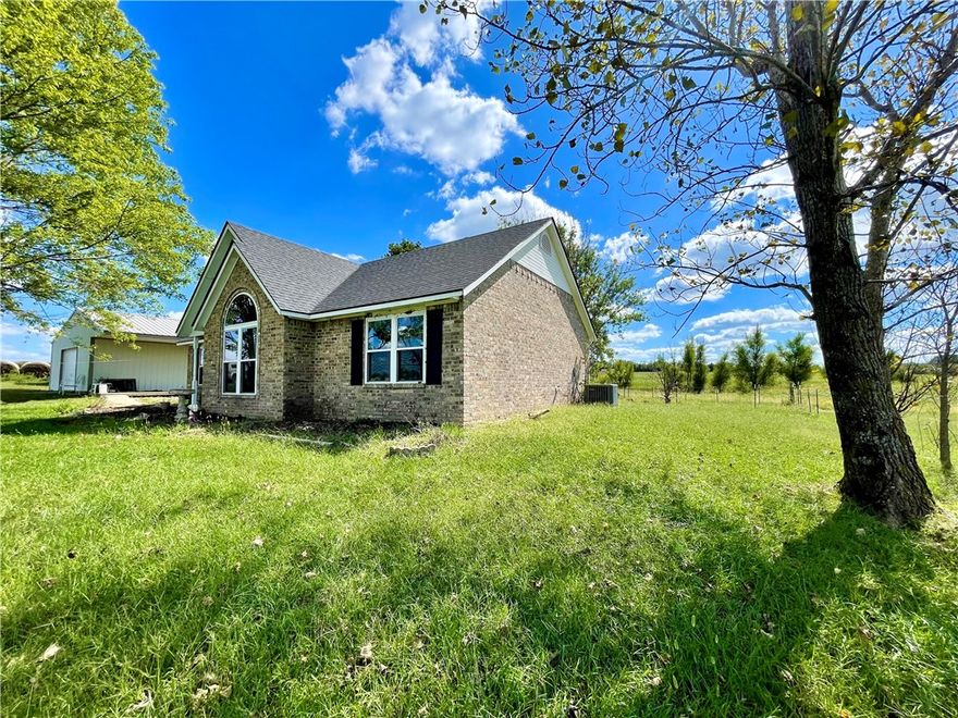 Great location on 2 acres in the Ozarks! Ideally situated for commuting throughout Northwest Arkansas, this residence boasts a 2-acre property with scenic views, featuring 3 bedrooms, 2 bathrooms, new windows, a new well pump, new heating and air conditioning, and a new roof. Propane wall unit for backup heat. Additional amenities include a 30-amp RV hookup, a 22x30 shop/outbuilding, and an 8x12 storage building. The property is partially enclosed with metal wire fencing on three sides, offering numerous possibilities. Conveniently located near Fayetteville and Springdale, with easy access to Huntsville, Wesley, and Elkins via highways 295, 45, 412, & 74.