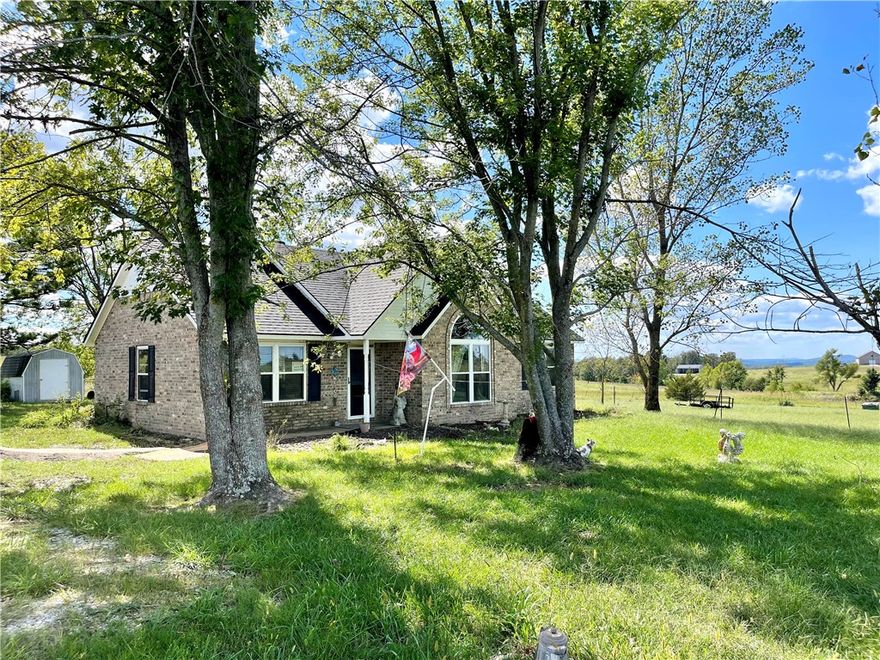 Great location on 2 acres in the Ozarks! Ideally situated for commuting throughout Northwest Arkansas, this residence boasts a 2-acre property with scenic views, featuring 3 bedrooms, 2 bathrooms, new windows, a new well pump, new heating and air conditioning, and a new roof. Propane wall unit for backup heat. Additional amenities include a 30-amp RV hookup, a 22x30 shop/outbuilding, and an 8x12 storage building. The property is partially enclosed with metal wire fencing on three sides, offering numerous possibilities. Conveniently located near Fayetteville and Springdale, with easy access to Huntsville, Wesley, and Elkins via highways 295, 45, 412, & 74.