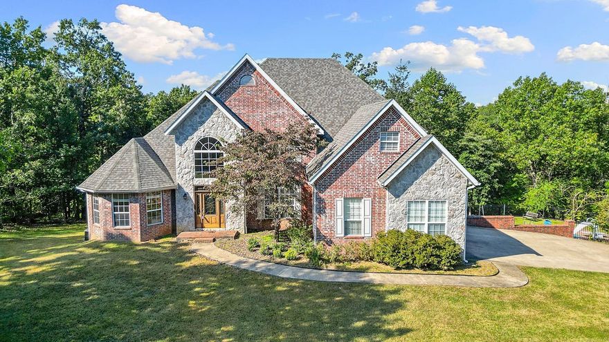 Discover timeless charm and modern luxury in this stunning 5-bedroom, 4 and 1/2-bathroom home nestled on 3.3 private acres just minutes from downtown Rogers and the scenic trails of Lake Atalanta. Crafted with a blend of brick and stone, this residence boasts: Grand Entryway with a sweeping staircase. Stone Fireplace anchoring the spacious living room. Large Open Windows flooding the home with natural light and offering serene views. Inground Pool perfect for entertaining or relaxing in your backyard oasis. Gourmet Kitchen with premium finishes and ample space for hosting. Five Generous Bedrooms including a luxurious primary suite. Four Full Bathrooms with elegant fixtures and spa-like touches with and additional half bathroom. Whether you're seeking tranquility, proximity to nature, or easy access to city amenities, this property delivers it all.