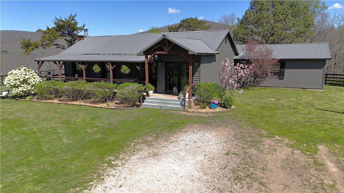 Experience Ozark Mountain views in all directions from this fabulous 3500 sqft, 3br2ba home on 53 acres. Inside you find beautiful modern finishes mixed with farmhouse character and living space galore! Open concept living area and kitchen are perfect for gathering. Welcoming foyer, large walk in pantry, professional sized gas range and refrigerator are a bonus. Luxurious master suite with sitting area, exercise room with sauna, and huge walk in closet. Secondary bedrooms with walk in closets are just as roomy. Additional closets for added storage and plenty of flexible space. Wonderful details and decorative touches throughout! Outdoors you find nice porch and deck areas to take in the scenery, fire pit, and a 3 car detached garage/shop. Enjoy peaceful living on the 53 acres of pasture land surrounded by woods AND joining 1000's of acres of National Forest. Property has 4 ponds, 2 wells and rural water. Hay barn, working pens, and fenced for cattle. So many features and possibilities in this gem of a property!