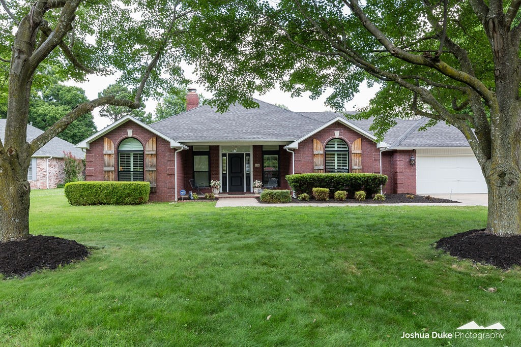 Beautiful centrally located Fayetteville home on half acre lot! This one level brick home features 3 bedrooms, 2.5 baths, plantation shutters throughout, new hardwood floors in living room, and a split floor plan. A modern gas fireplace is the star of this living room and creates cozy appeal. Kitchen has all stainless appliances, granite counters, a large bar, and eat-in kitchen. Primary suite includes vaulted ceiling with adjoining bath, quartz counters and tiled walk-in shower. Additional bedrooms are spacious and have access to a full bath. Large backyard is privacy fenced and is hard to find! This gem is close to everything including trails, restaurants, shopping, parks, and all Fayetteville has to offer! Schedule your private tour today!