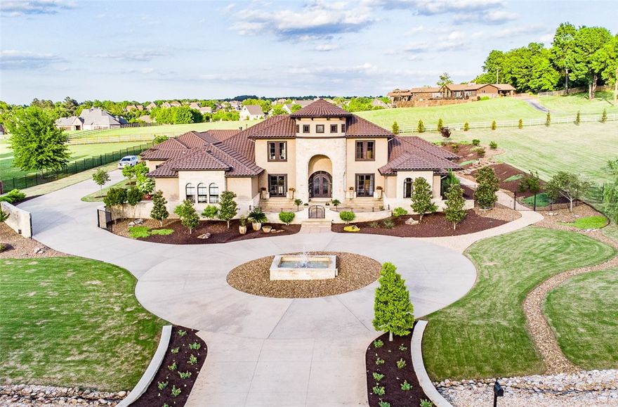 Custom Mediterranean inspired home features large living areas and a state of the art media room. The Main house sports an open floor plan, two master bedroom suites on the entry level and two guest bedroom suites separated by a sitting room, which overlooks the great room, on the second level. The Chefs kitchen features high end appliances. The 1209 sq ft guest house boasts two bedroom suites a living room & kitchen that overlooks the pool. With too many custom features to list, this home is a must see!