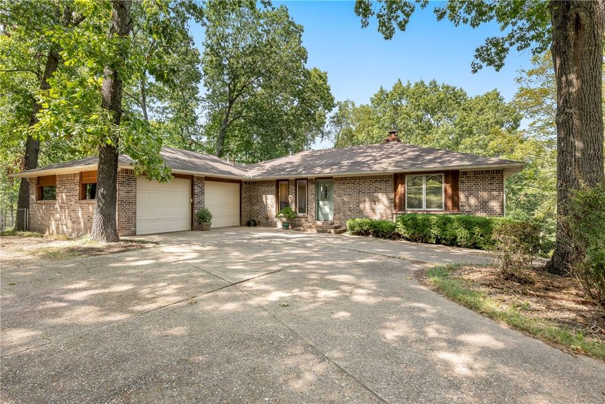 Let’s Go to the Lake!! Beautiful 4bd/3bth home right on Beaver Lake!  Covered boat dock w/swim deck!  10 Mins to DT Rogers! This home has beautiful natural light with open floor plan, finished walk-out basement, 2 tiered Deck, 3 car garage w/workshop  Basement has 2 bedrooms, living area, and area for kitchen/office and 2nd set of W/D connections.  Primary Bedroom has a nice sitting nook looking out over lake.   Kitchen is spacious w/dining area to the side all overlooking the lake.  This home is your future dream lake home!  Come see today!