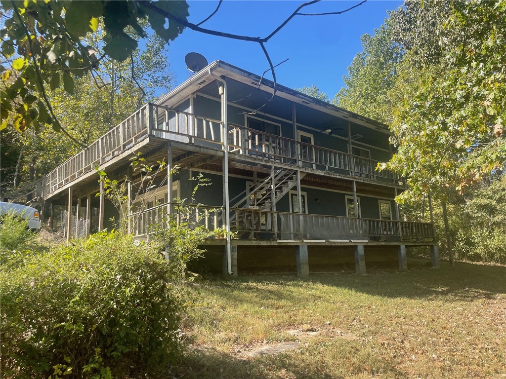 This property includes 11.17acres, 3 homes and several outbuildings. They have been vacated within the last year or two. There are 3 wells although 1865 and 1941 are using one presently but have shut offs. Water and electric up hill behind 2-story. Some remodeling done. Stream runs most of year but needs work or bridge rebuilt for ease of access. This is 4 parcels of land, 1 without improvements. Each home metered separately. Owner does not wish to divide property at this time. Is being sold as is-has potential for multiple homes or place for great building site up hill. Wildlife on the acreage, several outbuildings as well as the coolest tall rock formation. Tax amount on one parcel only-largest home. Iron horses in front will be removed.