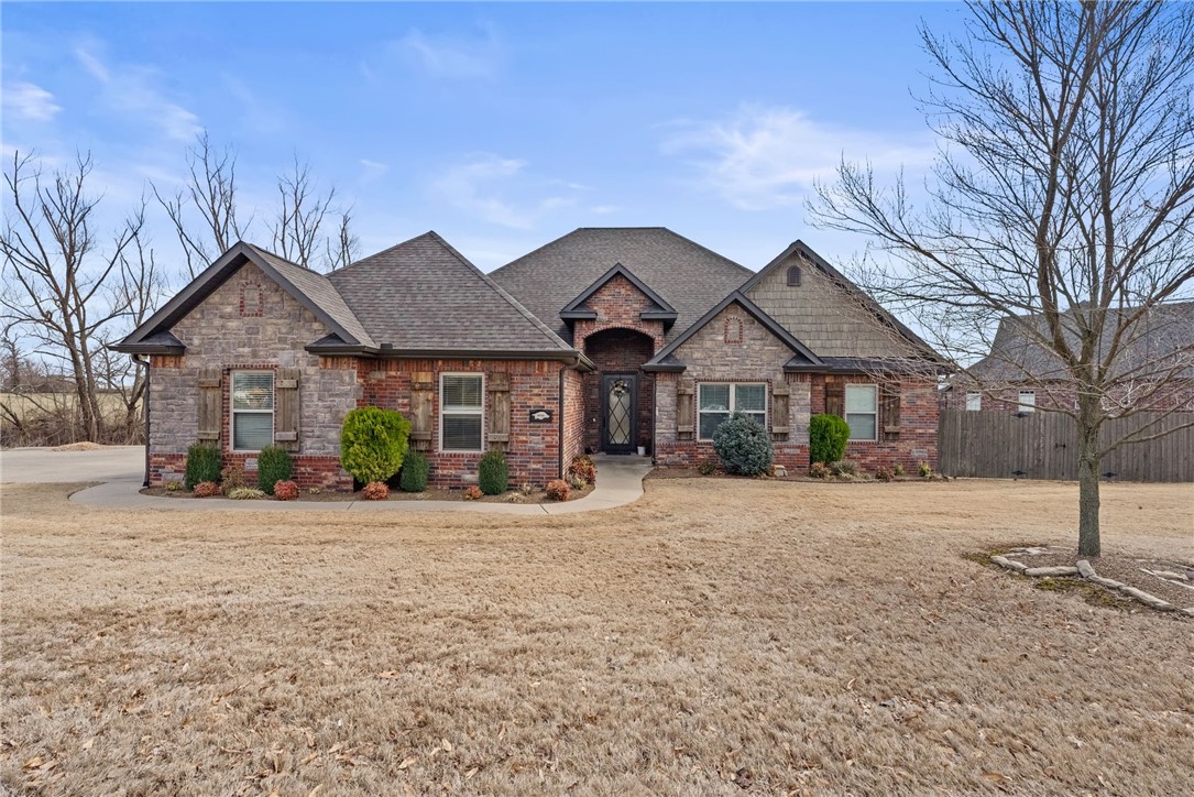 Welcome to Oxford Ridge! This gorgeous 4-bedroom, 2.5-bath home sits on a large corner lot within walking distance to the Bentonville Community Center. Or just walk across the street to your community pool! The open floor plan features all bedrooms on the first floor, including a flexible 4th bedroom/office. The primary suite offers an oversized shower with a rain shower head, built-in cabinet outlets, and a walk-thru laundry room.The chef’s kitchen includes a 5-burner gas stove, pantry, and ample storage. High-end touches include 3cm granite, recessed lighting, central vac, and wired sound in the living and media rooms. Upstairs, a top-notch media room boasts a 135-inch screen, HD projector, LED lighting, built-in lockers, and a half bath. The large backyard and covered patio are perfect for entertaining! A three-car garage includes a Tesla charging station and quick-access storm shelter. Located near shopping, and dining. Schedule your tour today!