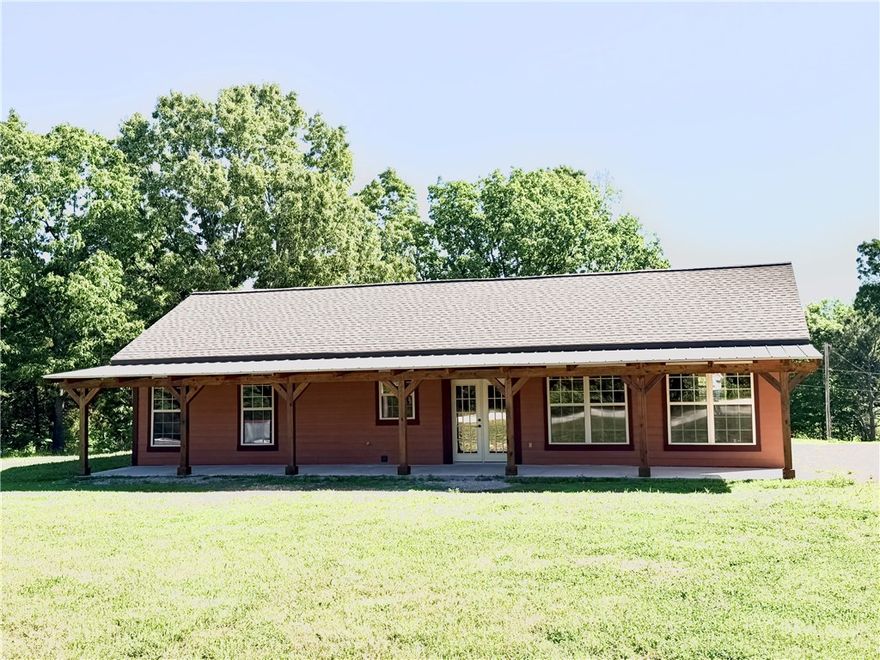 This newly constructed 3 bdrm, 2 ba home sits on a 1-acre packed with premium features. The property includes a massive shop building equipped with a concrete floor, electricity, a sliding door, & overhead storage, alongside a 4-stall pole barn. Expansive covered patios at front & back of the home. Inside, the striking living room boasts vaulted metal ceilings, rustic wood-paneled walls, large windows, & modern eight-blade ceiling fans. The gourmet kitchen has granite counters, multi-purpose sink, & a massive wall of pantry cabinets. Each bdrm has its own large walk-in closet, while the master bathroom delivers a spa-like experience with double sinks & an oversized shower featuring dual water sprayers. The interior showcases lifetime laminate flooring paired with elegant marble floors in the bathrooms & laundry room. High-quality PlyGem windows flood the home with natural light, and a modern PEX water manifold system allows for easy individual shut-offs to any interior water source. Possible owner financing.