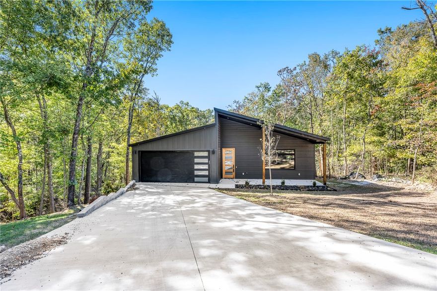Brand-New Home in Beautiful Bella Vista! Stunning 3BR/2BA new construction with 1,924 sqft of modern design and quality craftsmanship. The kitchen impresses with quartz counters, stainless steel Café appliances, soft-close cabinets, HUGE island, and a coffee bar that opens to a bright living area—perfect for entertaining. The primary suite boats a spacious walk-in closet and spa-like bathroom. Enjoy the Ozark landscape from your covered back patio. Just minutes from Lake Loch Lomond, Branchwood Rec Center & Trail, and Scottsdale Golf Course! Featuring an energy-efficient design, low-maintenance finishes, and built on a concrete slab to ease your crawl space fears :). Move-in ready and built to impress!