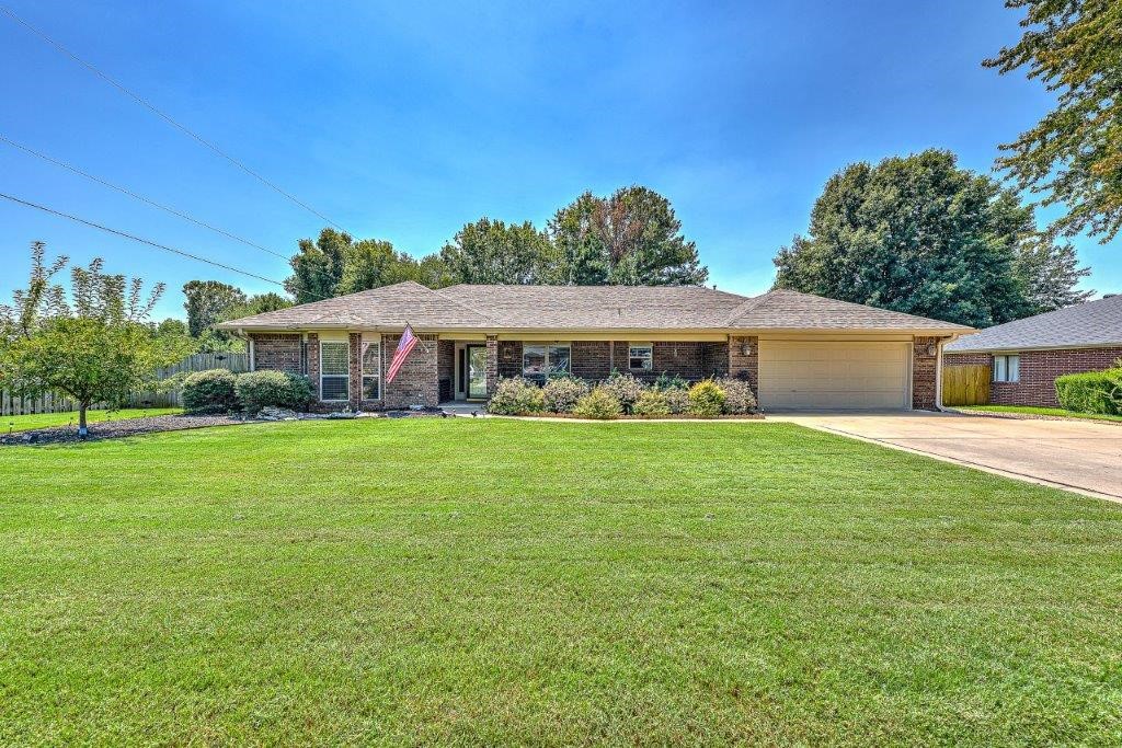 Private setting on dead-end street, 2 minutes to new Walmart Campus and I-49 access. Two living areas; One with gas log fireplace w/blowers and one with electric fireplace. Formal dining room. Kitchen features bar seating, pantry and gas cookstove. Abundant custom woodwork in the home. Custom countertops in bathrooms. Tray ceilings w/cedar accents. Primary suite features sliding doors to patio with custom barn doors for privacy. Front porch is covered. Roof new in May 2023. Water heater installed 2021. Two HVAC systems; One is approx two years old. Backyard is privacy fenced and has two double gates, also boasts patio for outdoor entertaining. The shop is amazing and has room for all the toys! Features a rollup door 7' walk through door. Epoxy flooring. Main room of shop is approx 18x22 with a 9x10 adjoining room. With a separate entrance, you'll find a 10x11 room with endless options in this heated shop. Workbenches convey.
