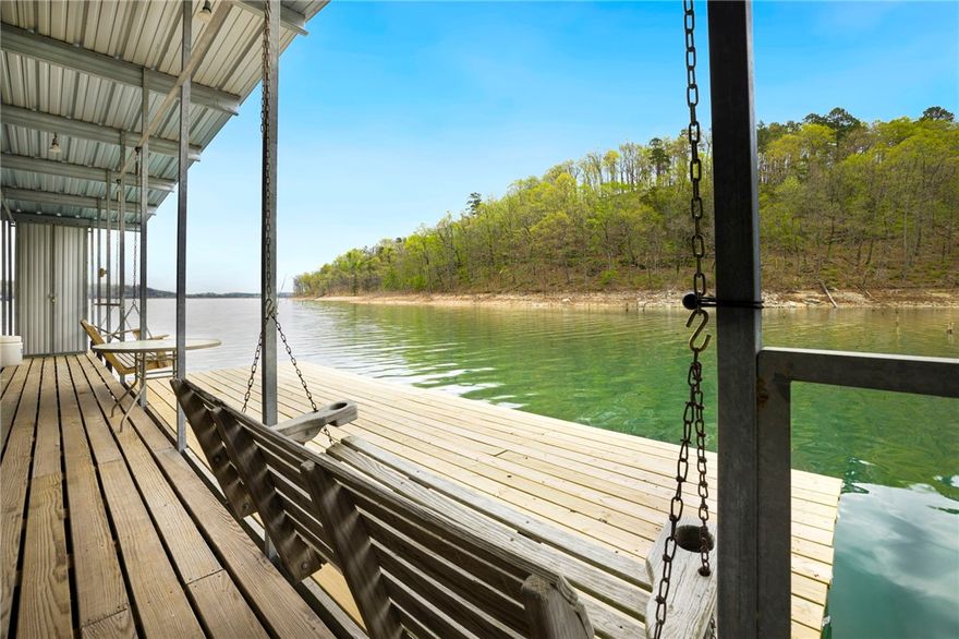 Discover this one of a kind custom build nestled in a private subdivision on Beaver Lake. 3,537sqft on 1.5 acres with 4 beds, 3.5 baths and 2 flex spaces offering a serene retreat with stunning lake views. Enjoy the convenience of a private slip on the community dock, providing easy access to the crystal-clear waters of Beaver Lake. With a prime location, this property is located in the Shaddox Branch lake area.  Just a quick 3-minute boat ride to Coppermine. Additionally, Prairie Creek Marina is easily accessible within 10-15 minutes, providing endless possibilities for lake adventures.  Cap off each day with unparalleled sunsets from your back porch, Or relaxing on your roof top deck creating the perfect backdrop for relaxation and creating lasting memories with loved ones.