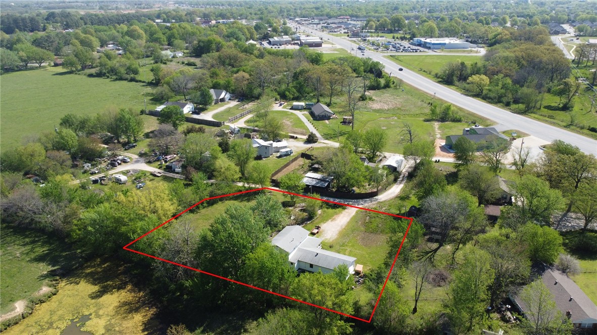 Investors and Flippers, come take this Farmhouse "Fixer" to "Fabulous"! Located just off Hwy 62 in Farmington, this home sits on 1 acre +/- backing up to a farmland view! 3 bed, 2.5 bath plus 12 x9 Flex room that could be used as an Office/Hobby Room/Nursery. All kitchen appliances, washer and dryer convey! Enjoy the country vibe this property has to offer with a spring that runs along the north property line, along with blackberries, a plum tree, 2 chicken coops and a big wooden covered front porch! Just bring the porch swing and rocking chairs! There is also an inground pool with pool shed that with some love could be another great space to enjoy outside! This property has SO much potential! Cash or Conventional only. Proof of Funds or Pre-approval required with any offers. Sold "As-Is"