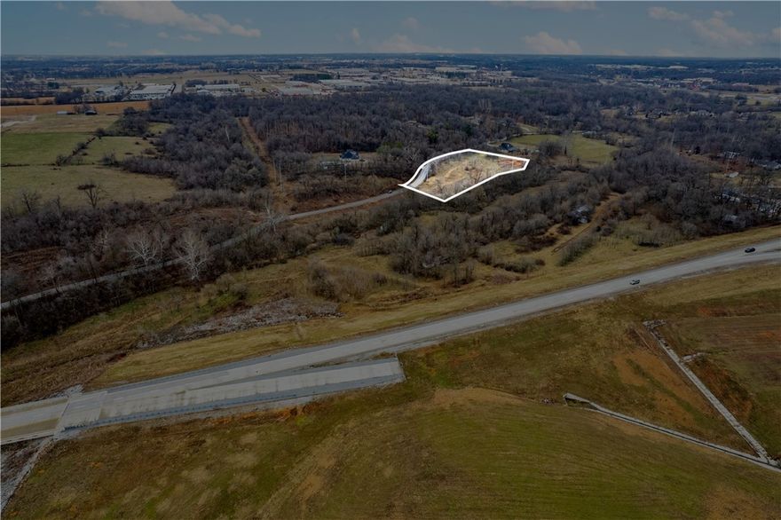 +/- 3.25 acre lot with convenient access to I-49! This property offers water access, and a sewer line that runs right down the middle of puppy creek. Zoned R-2 Immediate Neighborhood, it's an ideal site for residential development or select commercial projects. The lot also backs up to scenic Puppy Creek, adding natural appeal!