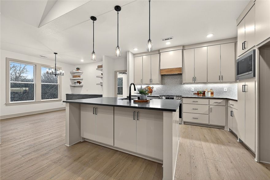 Stunning Modern Luxury Home with Breathtaking Ozark Views! Welcome to this exceptional single-story home, perfectly nestled on a quiet cul-de-sac w/ serene views next to Lake Ann. Designed w/ elegance & functionality in mind. Soaring cathedral ceilings & premium finishes throughout—no detail has been overlooked & no expense spared. Step inside to find Luxury Vinyl Plank flooring that flows seamlessly across the spacious layout. The great room is filled w/ natural light from oversized windows that showcase the beautiful Ozarks. The kitchen is an entertainer’s dream, featuring a massive island, tumbled quartz, and custom cabinetry. 3 bedrooms, 2 bathrooms, + an Office w/ built-ins. The primary suite is tucked away in it's own private wing; spa-like bathroom w/ a soaking tub & custom shower w/ full tile accent wall. Enjoy a large covered deck perfect for relaxing or entertaining. Oversized two-car garage with more cabinets. This home truly has it all: style, location, comfort, & views.