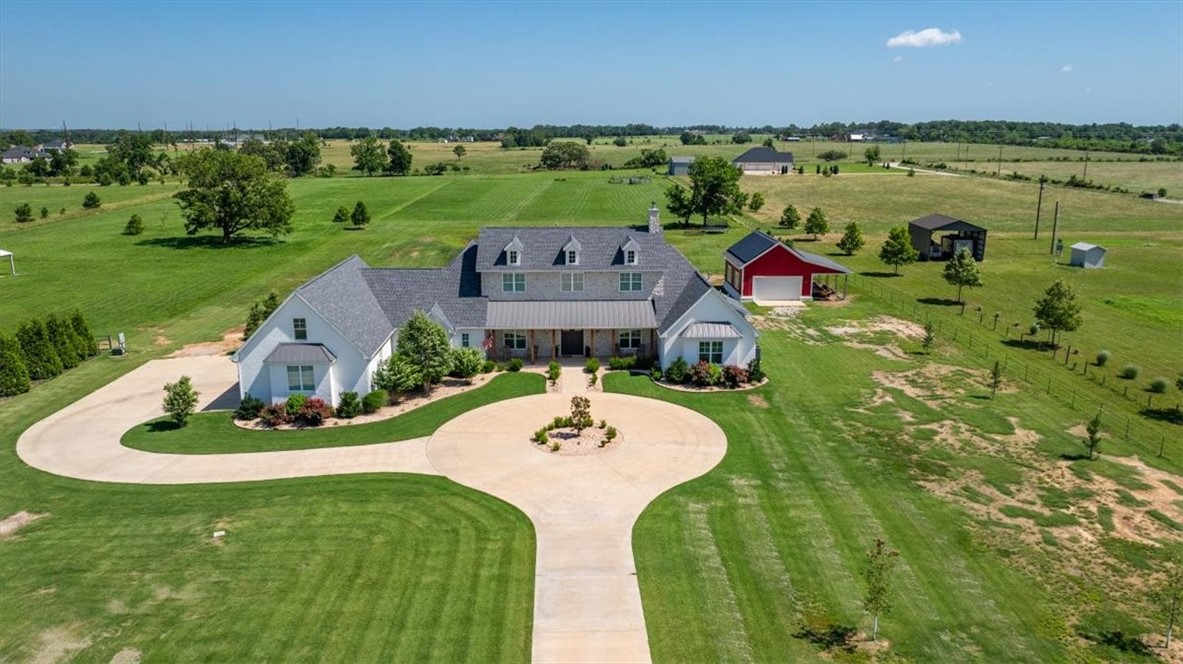 Stunning custom Colonial-style farmhouse on 5.4 acres in Bentonville with over 5,800 sq ft of living space and 1,400+ sq ft of covered patio. Main level features 3 spacious bedrooms with en-suite baths; upstairs offers 2 oversized bedrooms with a Jack & Jill bath. Chefās kitchen includes Wolf range, built-in fridge/freezer, farmhouse sink, ice maker, and custom cabinetry. Butlerās pantry with prep sink, floor-to-ceiling storage, and second dishwasher. Enjoy outdoor living with a large in-ground pool, mature landscaping, and multiple covered patios. Circular driveway adds curb appeal and convenience. Ideally located between XNA, Pinnacle Promenade, and downtown Bentonvilleāoffering luxury, privacy, and accessibility.