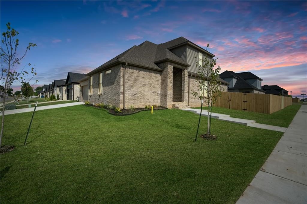 Welcome to brand-new construction in Walnut Grove Estates! This 4-bed, 3-bath home offers 2,361 sq ft of thoughtful design in an ideal Bentonville location near Vaughn Elementary, the airport, supermarkets and more. Enter into a bright open floor-plan featuring wood flooring throughout the main living areas and master suite, anchored by a dramatic floor-to-ceiling stone fireplace. The gourmet kitchen showcases custom cabinetry and stone countertops, while the master bath impresses with a rain-head shower system and a free-standing tub.  With an east-facing home on a fenced lot, gutters included, fence and blinds included and an established builder who’s delivered quality throughout, this home is move-in ready. Preferred lender is offering up to $3,500 in buyer concessions or rate buy downs!  Schedule your showing today.