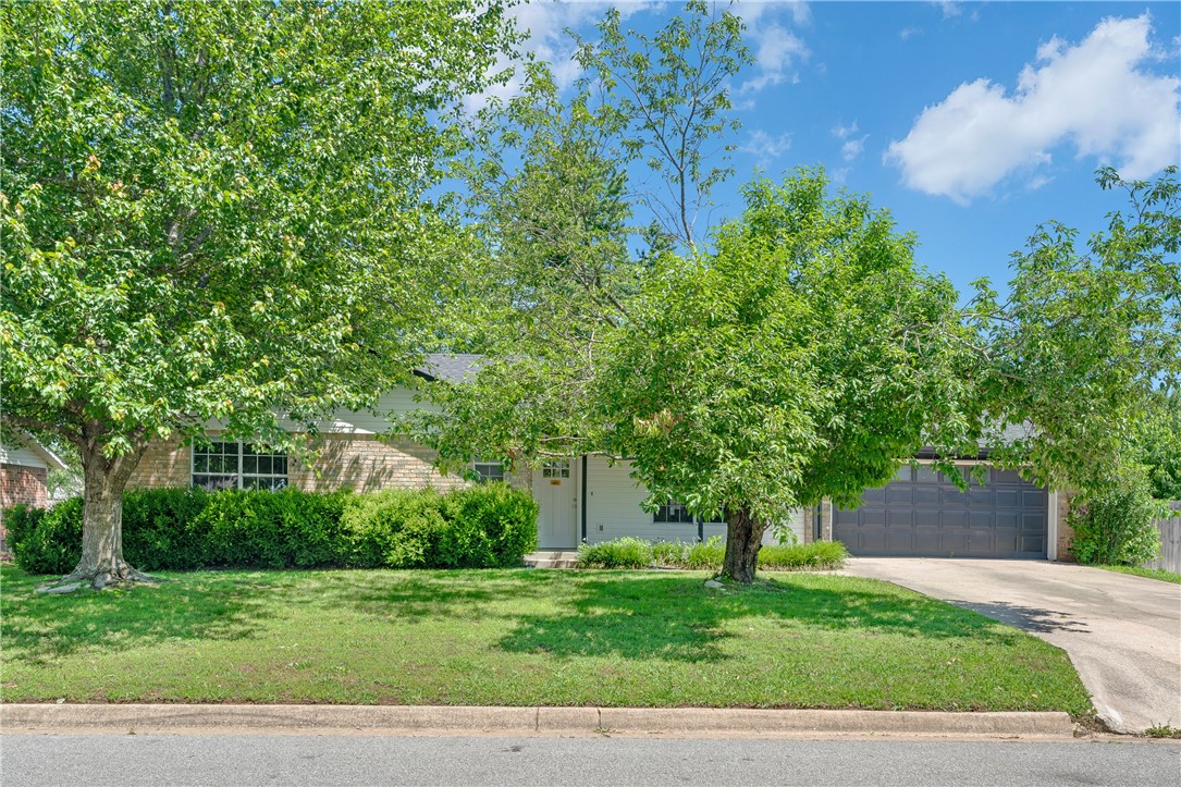 Experience comfort, space, and convenience in this inviting 3-bedroom, 2.5-bath home located in the heart of Rogers. Situated on a spacious lot, this well-maintained property offers a thoughtfully designed floor plan that balances everyday function with cozy charm. Step inside to a warm, welcoming living area anchored by a brick fireplace, where natural light flows through the common spaces, creating an open and inviting atmosphere perfect for relaxing or entertaining. The dining area easily fits a full table and opens to a kitchen with ample storage, granite counters, and a practical layout for easy meal prep. The primary suite features a walk-in closet and private bath, offering a quiet retreat from the main living areas. Two additional bedrooms share a well-appointed full bath, ideal for family, guests, or a home office. Tucked away in an established neighborhood just minutes from parks, schools, trails, and shopping, this home offers the perfect blend of comfort and location. *1% Preferred lender Credit*