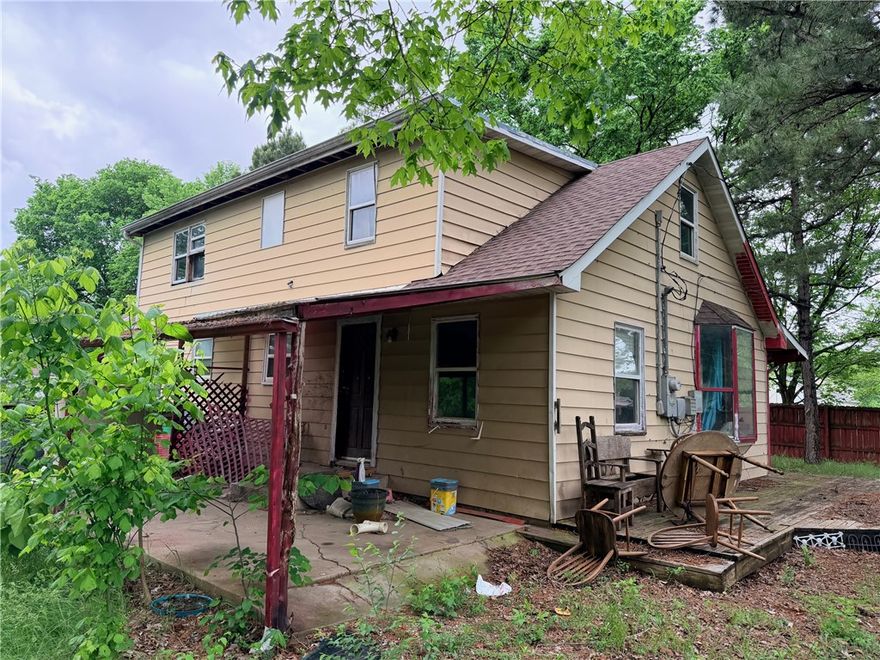 5 bd 2 ba home needs major remodeling.  Partial wood fence on two sides and chain link on one side. Covered front and back porches. Floors appear to be solid. 3 bd 1 ba on main floor and 2 bd 1 ba upstairs. Property will not go VA, RD or FHA. Utilities are turned off. Selling AS-IS; numbers are approximate.