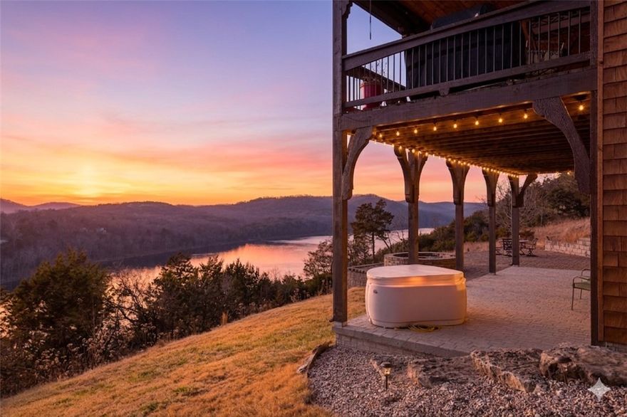 Step into elegance where the tranquil rhythm of the White River meets luxury of Table Rock Lk. Perched on 2.89 acres of stunning bluffs on the Island, this contemporary masterpiece invites you to panoramic views & architectural grace. Cathedral ceilings & magnificent multi-sided gas fireplace set the stage for cozy winter evenings, while the chef’s kitchen, 2 bars & entrtnmnt areas await your next gathering. The homes tells a tale of versatility and comfort; the primary suite- a private sanctuary, while the walk-out basement features full bar & covered deck. The 5-car det. garage isn't just for collectors—it features a charming apartment above, perfect for a creative studio/guest retreat. You aren't just buying a home; but a lifestyle. Mornings on the golf course, afternoons on the pickleball courts or in your garden & sunsets on the bluffs. More than a residence; it is a legacy of Ozark beauty & quiet sophistication, located mins from the vibrant culture of Eureka Springs. Semi-furn, boat/slip lift opt-SEE NOTES