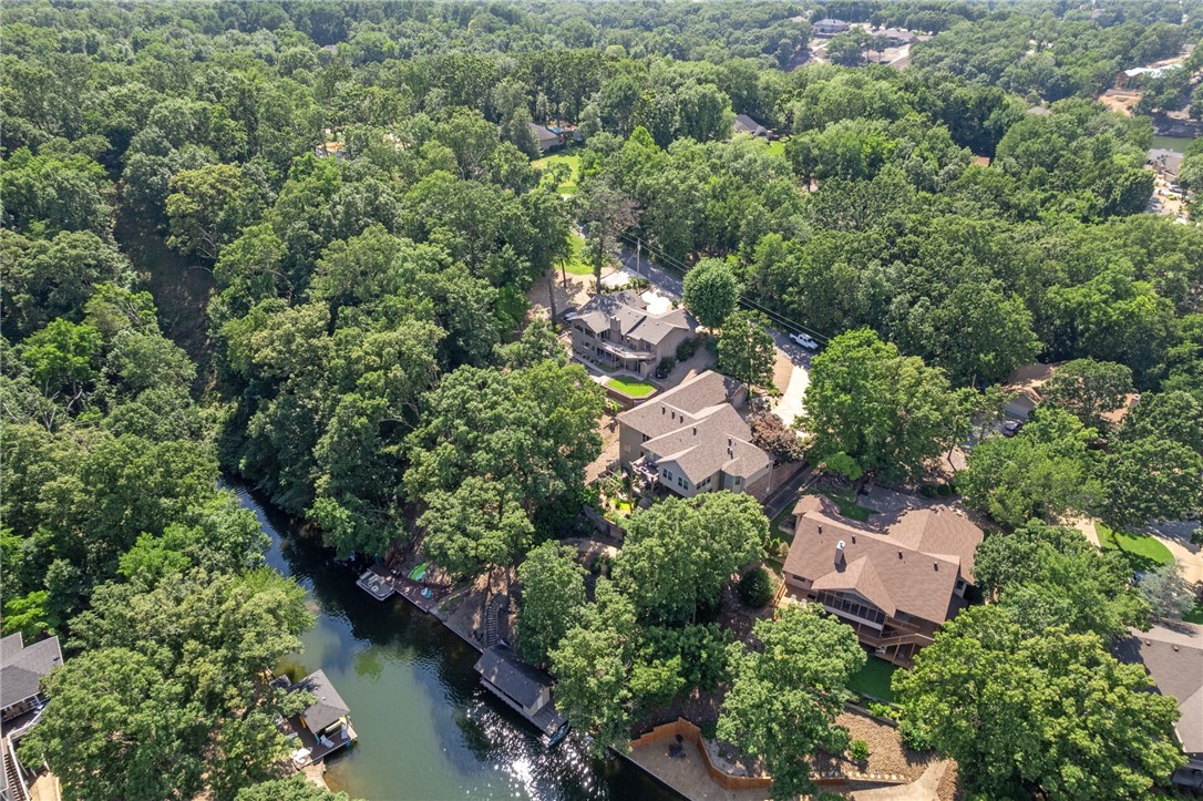 If youāve been dreaming of a lake home where privacy, outdoor living, & stunning water views come together, welcome to your perfect retreat on Loch Lomond. Nestled on .77 acres (includes add. .31 acre lot) this beautifully maintained home offers the ultimate lake lifestyle complete with your own private dock, boathouse, & a tram for easy access to the water. Inside, youāll find room to relax & entertain with 3 bdrms, 3 baths, 2 living areas, a designated dining rm, an eat-in kitchen, a sunroom, & a spacious back deck overlooking the lake. Designed to enjoy every season, the backyard space includes a hot tub, fire pit, & a brand-new set of stairs leading to the dock. Recent updates include: basement remodel, landscaping, sod, irrigation, paver patio, & fire pit, rock drainage canal, resurfaced dock, retaining wall, new roof/gutters, & deck resurfacing. Perfect for hosting friends & family-or simply savoring quiet mornings with nothing but the sound of water & trees around you. See Property Highlights for more info!