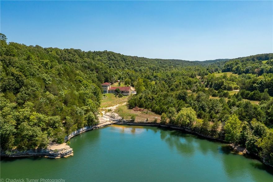 Seller called and is ready to move on.  Huge price reduction of $500,000... Once in a lifetime opportunity to own this gorgeous lakefront estate at Hogscald Hollow on Beaver Lake.  3 separate land parcels with 900 ft of lake frontage and 3 coveted boat slips.  Privacy is an understatement and the views are jaw dropping.  Lots of great building sites gorgeous lake views.  The home has soaring ceilings with gorgeous, exposed beams, stain glass windows, amazing hand-carved woodworking, inlayed wood flooring, Giant living spaces and covered patios with Million dollar views of Beaver Lake and the surroundings.  This would make the ultimate corporate retreat/resort or vacation destination.   Also see Matterport tour for full house tour.   New survey dated 4-2022 attached