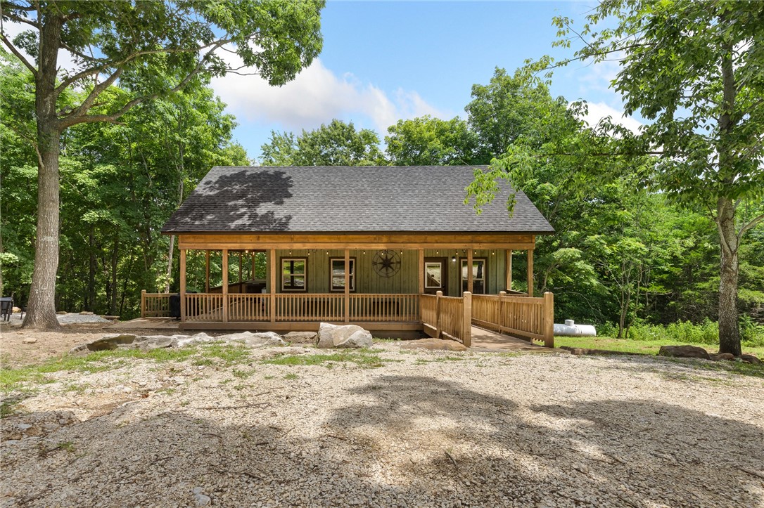 Escape to this stunning 1,205 sq ft, 3-bed, 2-bath home on 13.55 unrestricted acres with a spring and creek—just 400 ft off Hwy 7 and 5 minutes from town. Built in 2024 by Jeff Johnston and sold fully furnished, this handicap-accessible nightly rental features custom Ozark Cabinet Source cabinets, Oklahoma sandstone countertops, a spacious open layout, and stylish finishes. Enjoy year-round efficiency with a climate-controlled, encapsulated crawlspace and built-in dehumidifier. Relax in the hot tub, gather around the firepit, or explore four additional build sites—two with Old Hwy 7 frontage, all with water and electric. Minutes from the Buffalo River, Arkansas Grand Canyon, and Scenic Point. Appraisal and survey on file—ideal as a retreat, home, or investment!