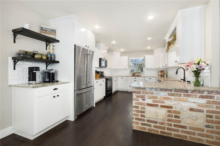 Welcome to a well-appointed 4-bedroom, 2-bath home offering comfortable living with thoughtful details throughout. The spacious kitchen features granite countertops, ample cabinet storage, generous prep space, and a dedicated coffee bar area. A brick accent detail carries seamlessly from the kitchen into the living room, complementing the cozy gas fireplace and creating a cohesive, inviting atmosphere. Vaulted ceilings with a wood beam accent add warmth and character to the large main living space. The primary suite provides a private retreat with dual sinks, a jetted tub, walk-in shower, and a large walk-in closet complete with built-in shelving in the en-suite bathroom. Three additional bedrooms offer flexibility for guests, family, or a home office. Outside, a fenced backyard with a covered deck is ideal for relaxing or entertaining, while a wooded area behind the fence provides added privacy. This charming home offers an inviting setting in a growing Northwest Arkansas community.