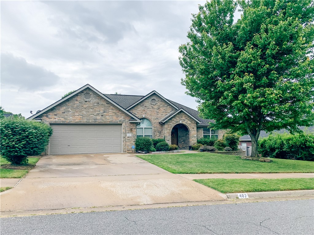 Welcome to 407 NW Saddlebrook Drive in Bentonville! This charming 3-bed, 2-bath home offers 2,349 sq. ft. of comfortable living space with a split floor plan. The spacious primary suite features a walk-in closet, while the open-concept living area boasts high ceilings, a cozy fireplace, and natural light. The kitchen includes ample storage, a breakfast area, and elegant cabinetry, perfect for everyday living. A formal dining room adds a touch of elegance for entertaining. Outside, enjoy a covered deck and fenced backyard, ideal for relaxing or outdoor gatherings. Located near Coler Mountain Bike Preserve and Walton Blvd, this home offers easy access to trails, shopping, and dining. A two-car garage and well-maintained landscaping complete this beautiful home. Don’t miss your chance—schedule a tour today! Lawn Care is included. Not furnished. Photos taken from prior listing.