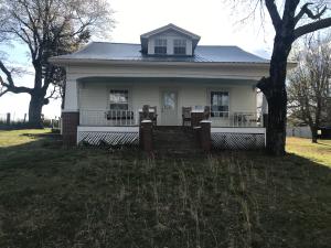 WOW!! Neat old farm house on 13+ acres that joins / borders the Ozark National Forest with paved highway frontage. This 3 BR, 1 BA, home features wood floors, older door knobs, covered front porch (33' x 8'), metal roof (2015), vinyl windows (2009), vinyl siding (2009), and much more. The home is currently on rural water or you can also use the original hand dug water well. Several older outbuildings including a large barn, cellar, shed, carport, and garage. The land is mostly level hay pasture with a nice pond. Plus the property sits private with no close neighbors and has a nice view. This is a must see.
