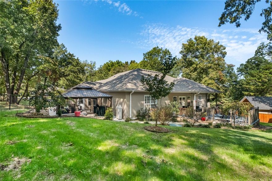 Spacious Bella Vista Retreat !!! This 2,127 sq ft, 3-bedroom, 2-bath home offers the perfect mix of comfort and style. Tucked away in a quiet cul-de-sac, the super-sized living room flows seamlessly outdoors to your private oasis with multiple porches and a covered area—ideal for relaxing or entertaining. A large eat-in kitchen anchors the home, complemented by a bright sunroom and extra dining space perfect for holiday gatherings. The split floor plan, high ceilings, walk-in closets, and cozy gas fireplace create a warm and inviting atmosphere. Outside, enjoy landscaped grounds from front to back, a fully fenced backyard, and a charming front courtyard. A double-car garage completes this move-in ready home.