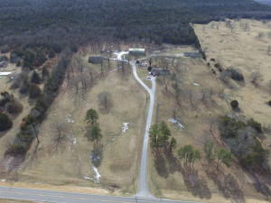 Very nice property located just outside of Berryville city limits, 20 acres m/l more than 1/2 open in pasture, large trees, fenced for horses, Custom Home built in 1997 Brick exterior, 3BR,2BA, 2 car garage, Second home built in 2003, 1,440 sq,ft, 2BR, 2BA, 2 car garage, Third home built in 1970 3BR, 1BA, one car garage. 40x60 shop with full bath and office, 40x20 additional under roof, 10x10 storm shelter, paved driveway, great views from the front porch. Shown by appointment.