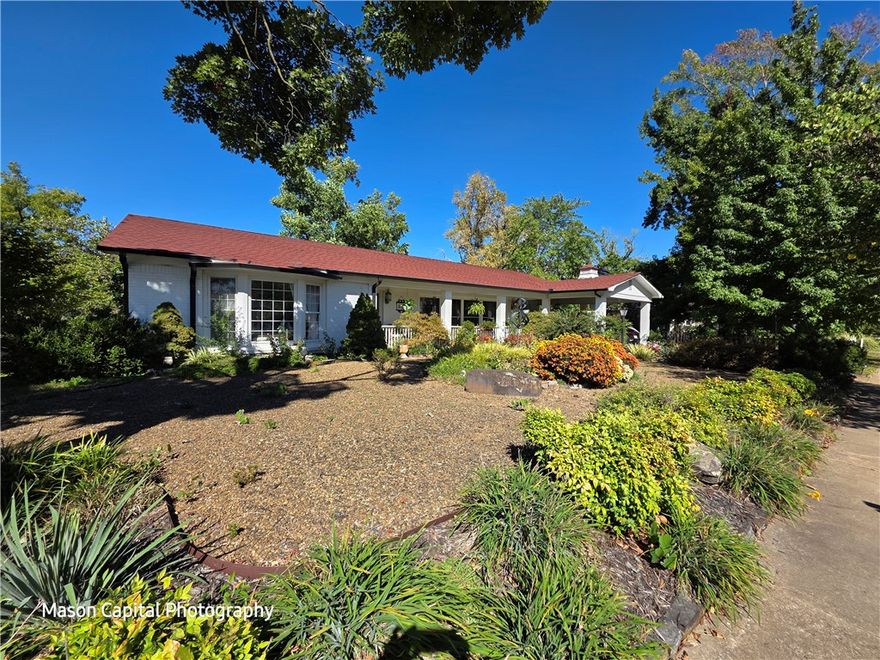 This remarkable property encompasses a 0.31-acre lot, featuring a main house of 3,018 Sq Ft as well as a charming 1-bedroom bungalow measuring 688 Sq Ft. The primary home overlooks W Central Avenue with an inviting open floor plan enhanced by its historical architectural details. The expansive living areas are perfect for entertaining The living room boasts, refinished wood flooring and a wide array of windows that bathe the space in natural light. The heart of the home is the dining area, which effortlessly connects to a spacious second living area. A covered patio invites you to a private garden. The property occupies an entire block bordered by W Central Ave, F St, and NW 2nd St, presenting opportunities for development. Located within walking distance of downtown Bentonville, and its many attractions of dining, shopping, bike trails, and more. Residences feature separate addresses and utility metering, presenting excellent income potential. The fully furnished bungalow successfully rents as a 1-bedroom bungalow
