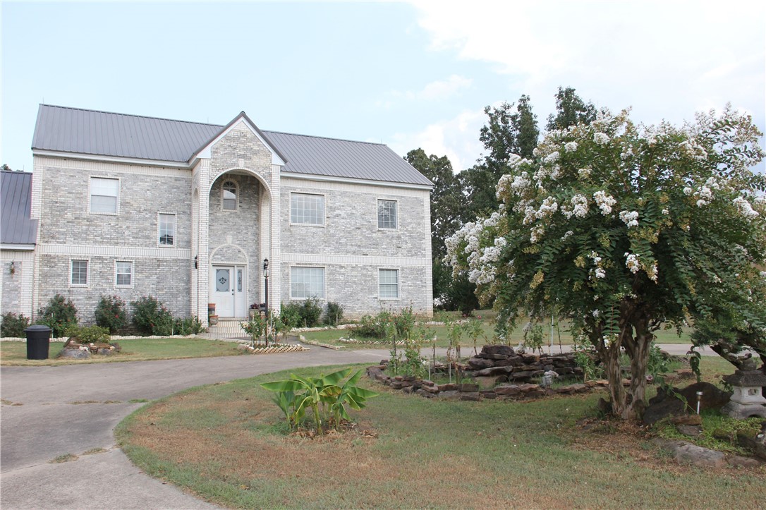 This beautiful two story brick home is located on Lake Dardanelle in a quiet subdivision on 2.06 acres of land. It offers wonderful views of the lake from every room in the house. It has a balcony off the master bedroom on the 2nd floor to sit and enjoy coffee for the sun rise and lemonade for the sun sets. The floor plan is open with a brick fireplace. The home consists of four bedrooms upstairs with one downstairs, and 2 full baths upstairs and one downstairs to accommodate a large family. The garage has attic storage and an additional large storage room.