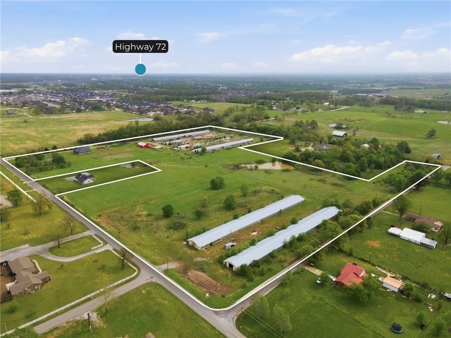 Rare opportunity to own 33 +/- acres positioned along the rapidly expanding west side of Centerton. Located just minutes from Hwy 102 and near local schools, this property sits within an area experiencing continued residential growth, nearby subdivision activity, and ongoing infrastructure improvements. City water, electric, and gas available on site, with sewer located at the road at the property corner (buyer to verify access, capacity, and connection requirements). With frontage along three roads, the property offers flexible access and layout potential. Improvements include a single-family home, oversized insulated shop, and six poultry barns.