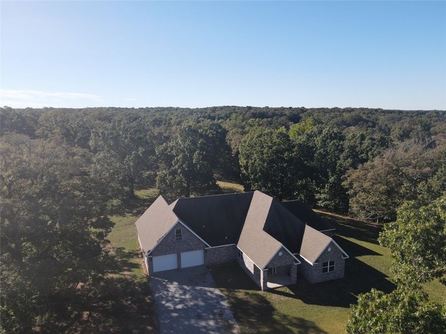 Beautiful setting with live water from multiple streams. So much incredible potential here. 2800+ sq foot home that needs a little exterior cosmetics and landscaping. Garage needs finished out and doors added to the home. Acreage is a mix of open & hard wood with multiple spring fed ponds along with multiple live water streams across the property. Come enjoy your private retreat and surround yourself with lovely views..