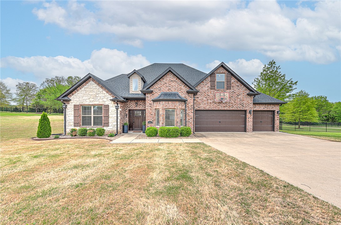 Perfectly situated between Fayetteville and Springdale, this stunning single-family home offers both convenience and luxury. Inside, you'll find granite countertops throughout, beautiful hardwood floors, and an upgraded kitchen equipped with stainless steel appliances, a gas range, and a pantry.
The main floor features a large laundry room, along with a primary suite and a second bedroom with on-suite ideal for guests or a home office. Upstairs, enjoy two additional spacious bedrooms and a massive bonus room, perfect for a playroom, media space, or gym.
Step outside to your private backyard oasis complete with a covered patio and a in-ground swimming pool, all nestled on a generous 1.2-acre lot.